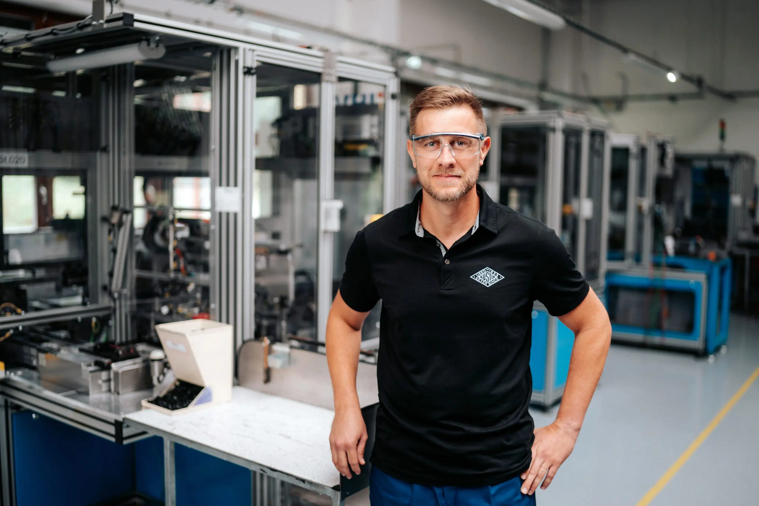 Worker posing next to workstation