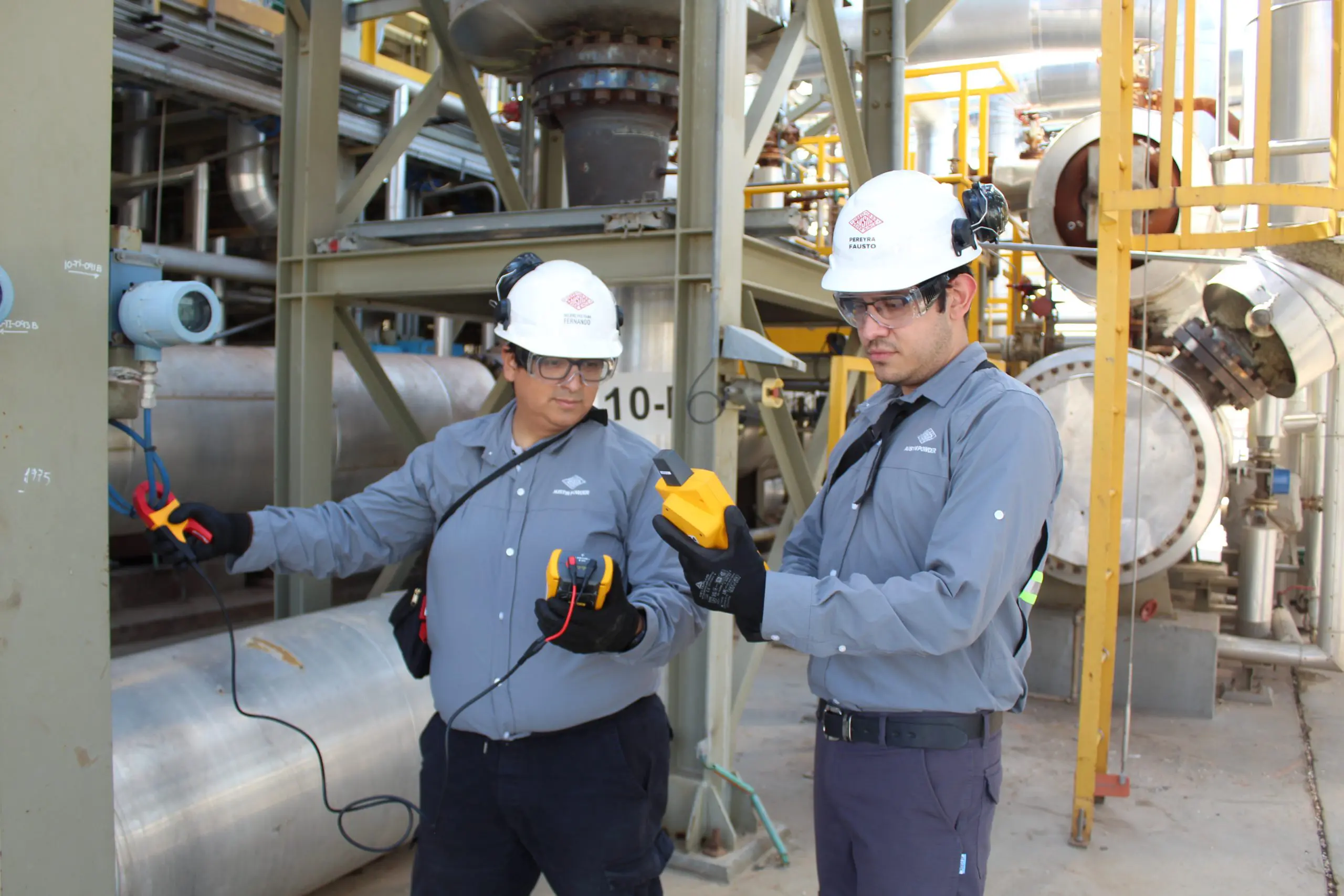 Workers testing equipment
